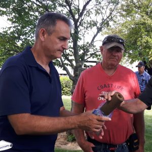 Kevin Jakubec of Water Wells First and landowner Laurier Cartier examine a clogged filter. 