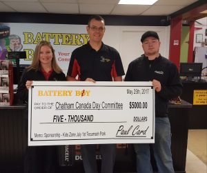 Kristie Trealout-Card and Paul Card present the cheque to Chris Glassford, Chair of Chatham Canada Day.