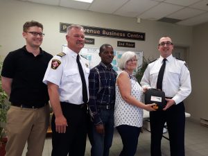 CK-FES personnel install a new AED at Chatham's Park Avenue Business Centre, which houses multiple offices and community meeting rooms. 