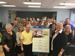 Photo – shown displaying the new vision, mission, and values is new Board Chair Dave Macko (left) and past Board Chair Jennifer Wilson (right).